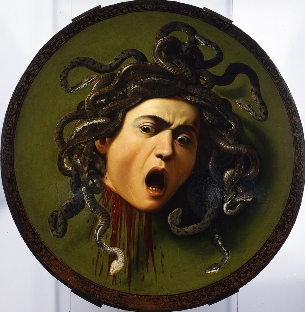 É possível separar a arte do artista? - Quadro Medusa de Caravaggio, a cabeça do monstro mitológico olha com espanto sobre um fundo verde e ensanguentado